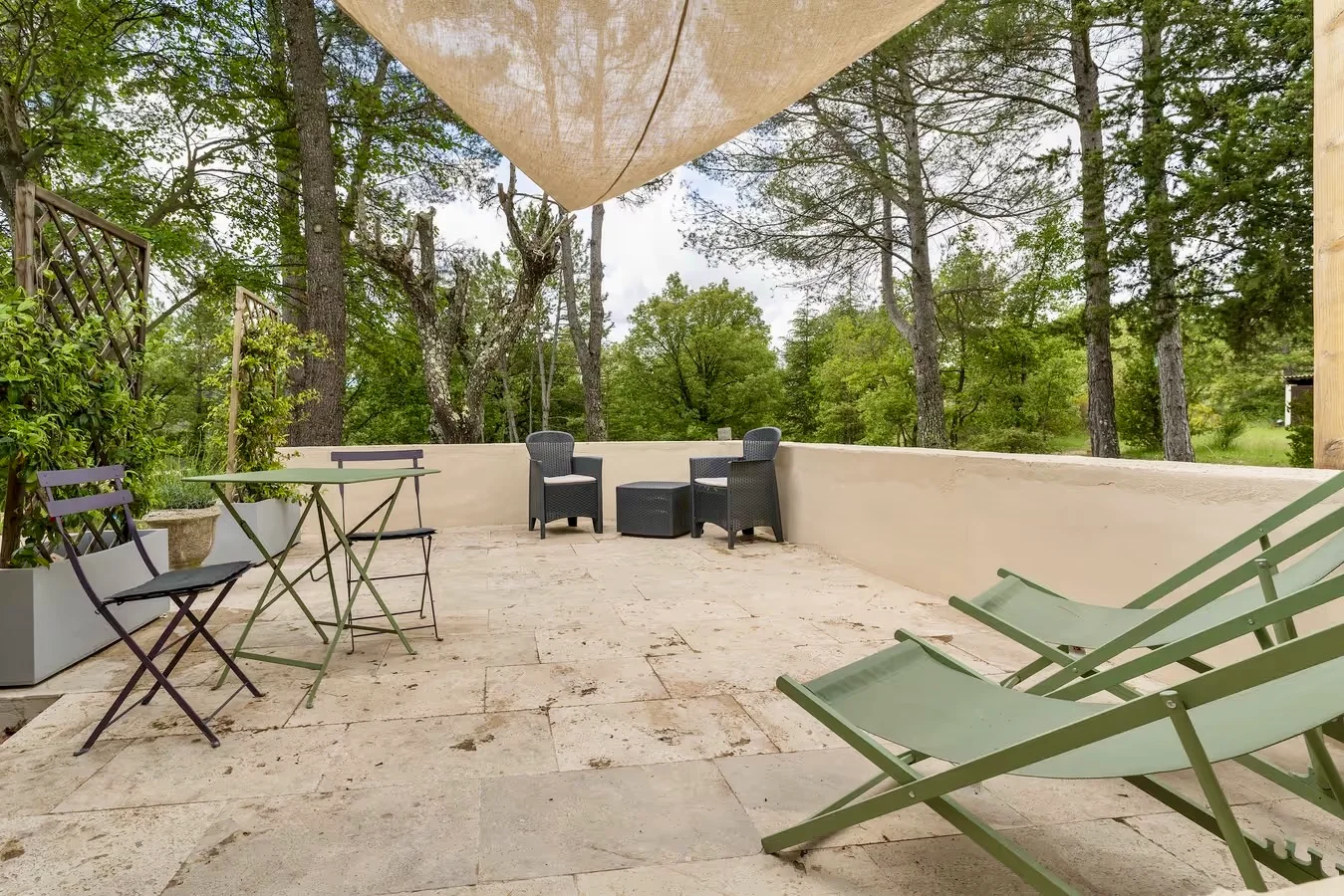 Grande terrasse en pierre sous les pins
